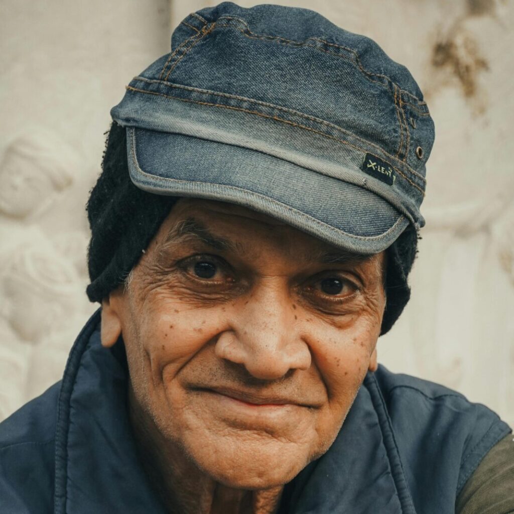 Close-up portrait of an elderly man in Ahmedabad, India, showcasing rich cultural attire and expressions.