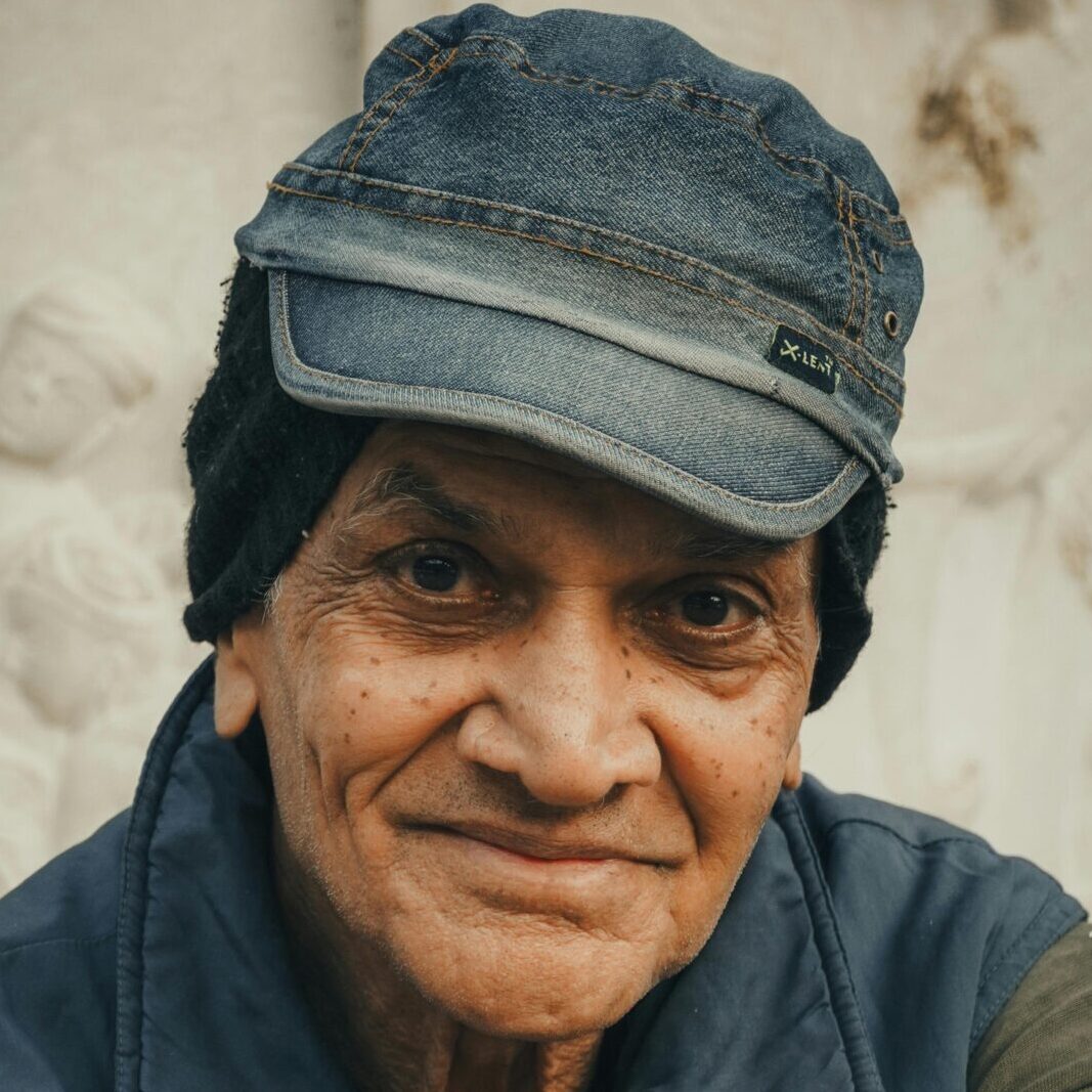 Close-up portrait of an elderly man in Ahmedabad, India, showcasing rich cultural attire and expressions.